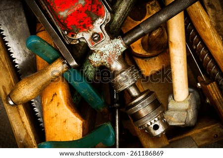Old working tools. Vintage working tools on wooden background.