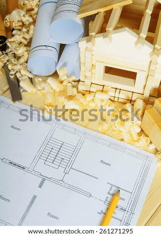 Planning of repair of the house. Joiner\'s works. Drawings for building, small wooden house and working tools on wooden background.