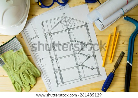 Planning of repair of the house. Repair work. Drawings for building, helmet, mount and others tools on wooden background.
