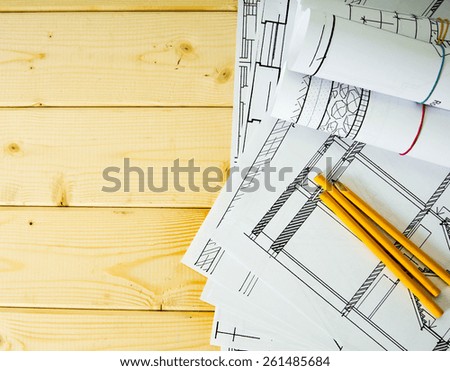 We build a building. House construction. Many drawings for building and pencils on a wooden background.