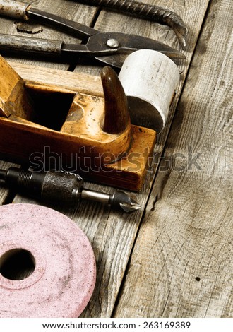 Old working tools. Many working tools on a wooden background.