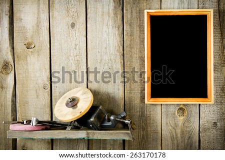 Old working tools. Many old tools and frame on a wooden background.