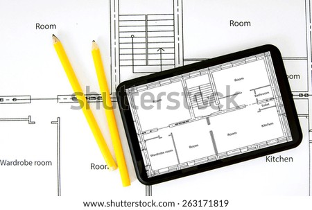 Planning of construction of the house. Tablet, drawings and working tools.