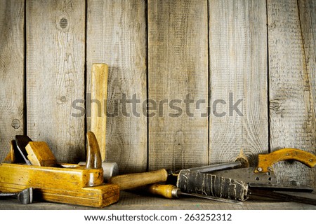 Old working tools. Many old tools (plane, mallet and others) on a wooden shelf.