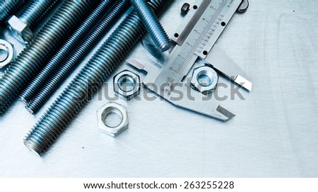 Metal tools. Ã�Â¡aliper and metal hairpins on the scratched metal background.