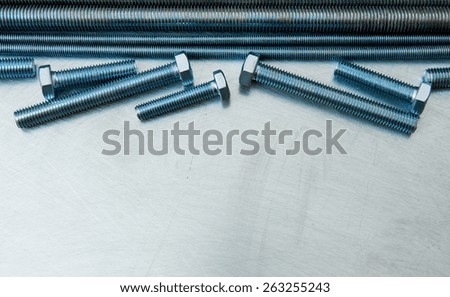 Metal tools. Metal style. Metal hairpins and bolts on the scratched metal background.