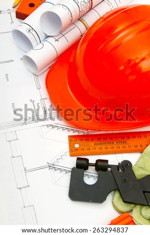 Planning of construction of the house. Drawings for building house, helmet and other working tools.