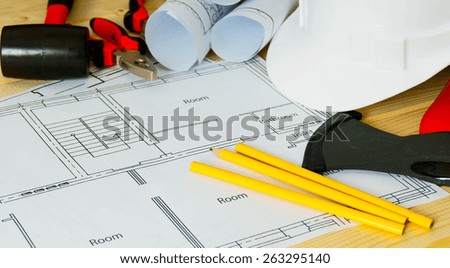 Planning of repair of the house. House construction. Drawings for building, helmet and others tools on wooden background.