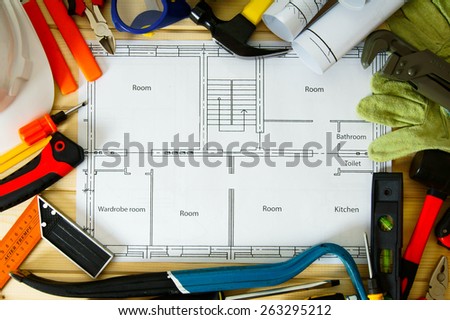 Planning of repair of the house. House construction. Drawings for building and many others tools on wooden background.