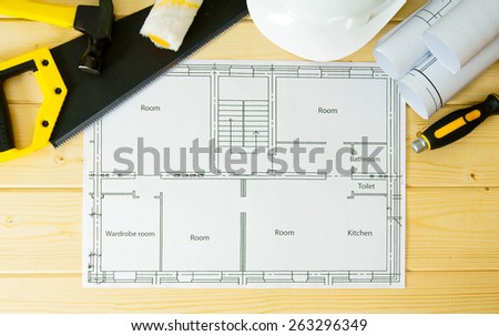 Planning of repair of the house. Repair work. Drawings for building, saw, hammer and others tools on wooden background.