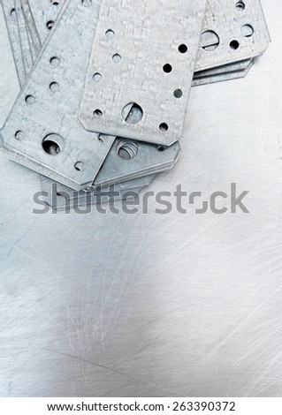 Metal working tools. Metal style. Metal preparations and fixing elements on the scratched metal background.