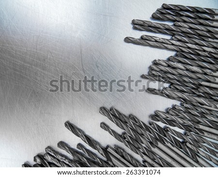 Metal tools. Metal style. Drills on the scratched metal background.