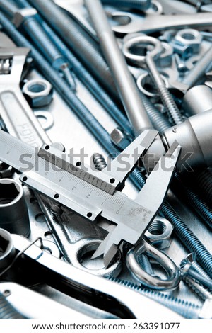 Metal tools. Metal style. Caliper and metal tools on the scratched metal background.