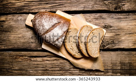Sliced rye bread on a Board. On a wooden table. Top view