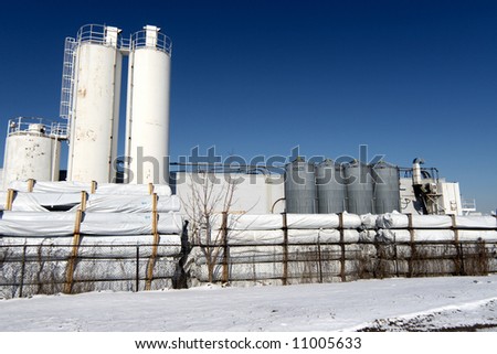 Chemical factory with snow and blue sky