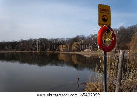 ring-buoy and rescue sign on a parking pond in the middle of High Park, Toronto