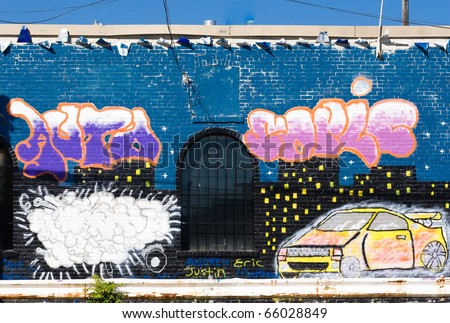 TORONTO, ON, CANADA - DEC 10: Blue, violet and white graffiti with a yellow car, created for Christmas season on a brick wall on Dec 12, 2008 at downtown district of Toronto, Canada