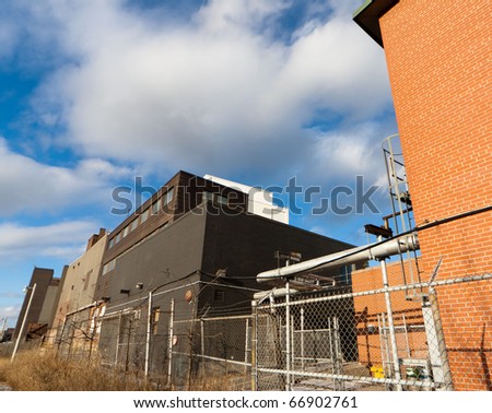 Black warehouse and orange brick wall on front at prom-zone of Toronto west, Canada