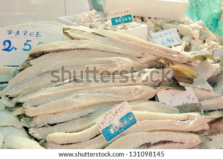 Dried, salted cod (aka bacalao salado) and other fish products priced in euros for sale at an open air market at a village or town fair (aka fete), province of Tarragona, Catalonia, Spain