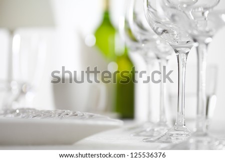 Luxury elegant dinner table setting in restaurant or hotel with wine glasses and white wine