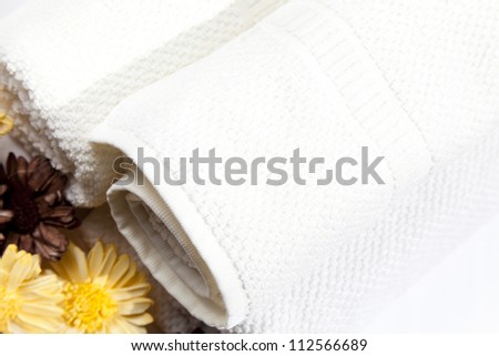 Soft white towels with dry flowers