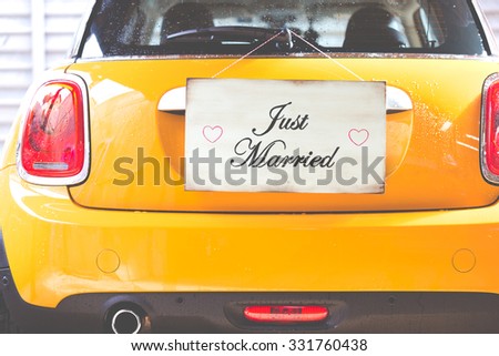 Just Married poster hanging on a wooden wall