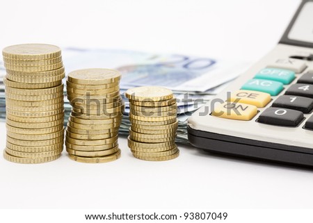 Euro notes and coins stacked on a white background