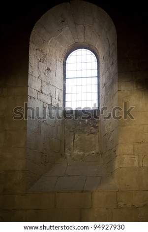Dim light of a window of a medieval church