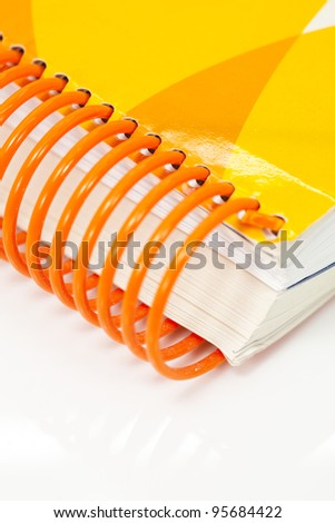 Spine of a book with plastic rings orange