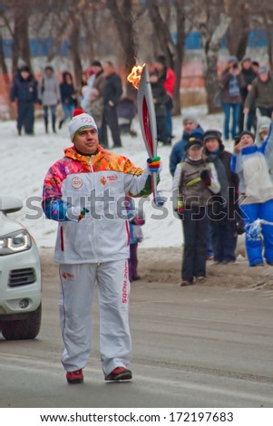 Novosibirsk, Russia - December 7, 2013 - torchbearer carries the Olympic flame in relay of Olympic flame.