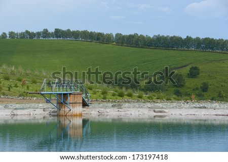 Diving board on a background green meadows