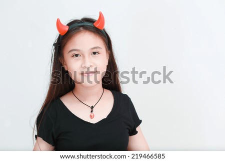 Portrait of little girl with devil horn