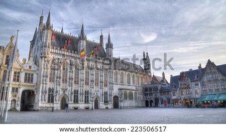 BRUGGE, BELGIUM - SEPTEMBER 17, 2014: The Burg square and facade of gothic town hall.