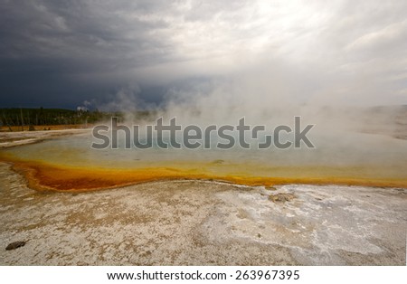 Storm Clouds over Sapphire Pool in Biscuit Basin in Yellowstone National park in Wyoming