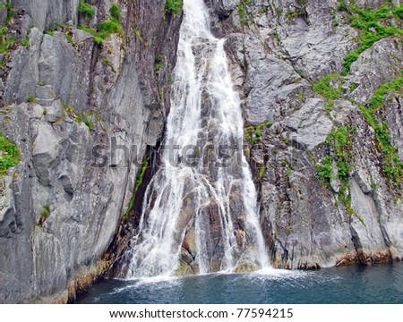 This waterfall is found rushing to the ocean from glaciers in Kenai Fjords National park