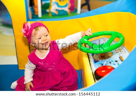 Happy baby girl  keep on board ship on playground. The concept of childhood and holiday