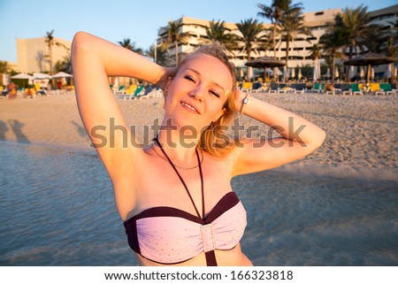 Beautiful woman on background of beach. Persian Gulf ,Dubai.Tanning girl near ocean, tropical resort, summer holiday