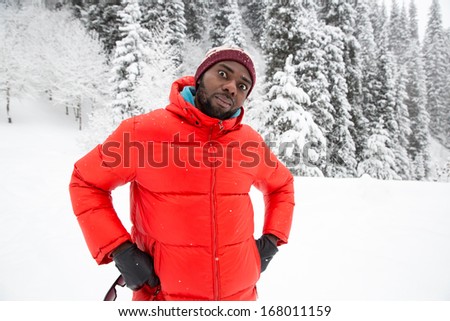 African American Cheerful black man in ski suit in snowy winter outdoors, Almaty, Kazakhstan, Asia