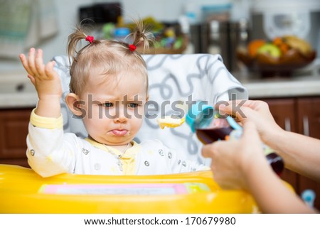 Child girl with bottle with infant formula on kitchen. Use it for child, healthy food concept