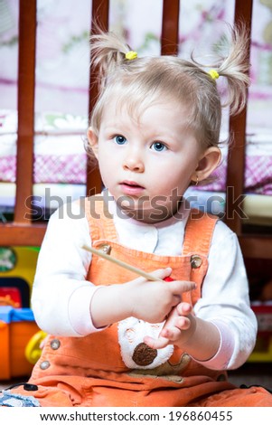 Little cute child girl with musical instrument. Use it for baby, parenting or love concept