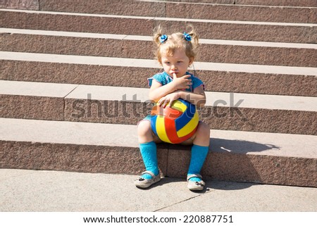 Adorable little child girl with toy ball in park.  Use it for baby, parenting or love concept