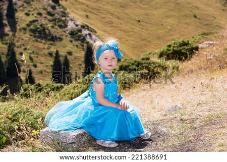 Adorable little child girl on grass on meadow. Summer green nature . Use it for baby parenting or love concept