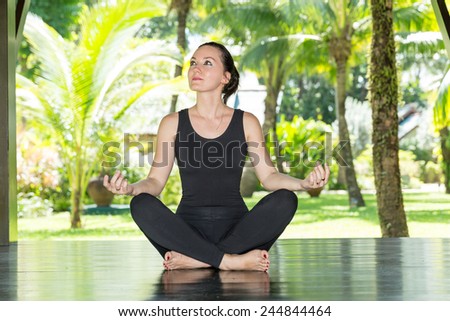 Young woman is practicing yoga and pilates on nature. Morning meditation at summer
