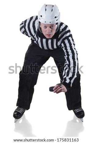 Hockey referee holding a puck in face off position. Front view. White background with shadow.