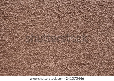 rough cemented surface in light maroon color. may be used as background or texture