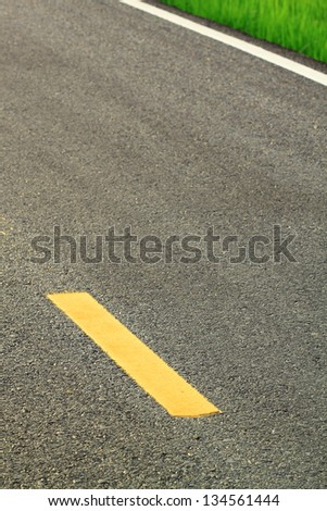 Asphalt road texture with yellow stripe