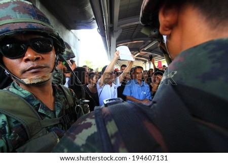 BANGKOK - MAY 24: A small group of unidentified people holding banners during a rally to condemn the Military coup on May 24, 2014 in Bangkok, Thailand.