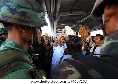 BANGKOK - MAY 24: A small group of unidentified people holding banners during a rally to condemn the Military coup on May 24, 2014 in Bangkok, Thailand.