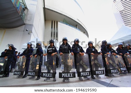 BANGKOK - MAY 24: Riot police stand guard on Bangkok art and culture centre during a violent anti-Military coup on May 24, 2014 in Bangkok, Thailand.