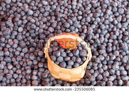 bast basket with bilberry berries against berries basket with bilberry on a counter of shop bast basket with bilberry berries
